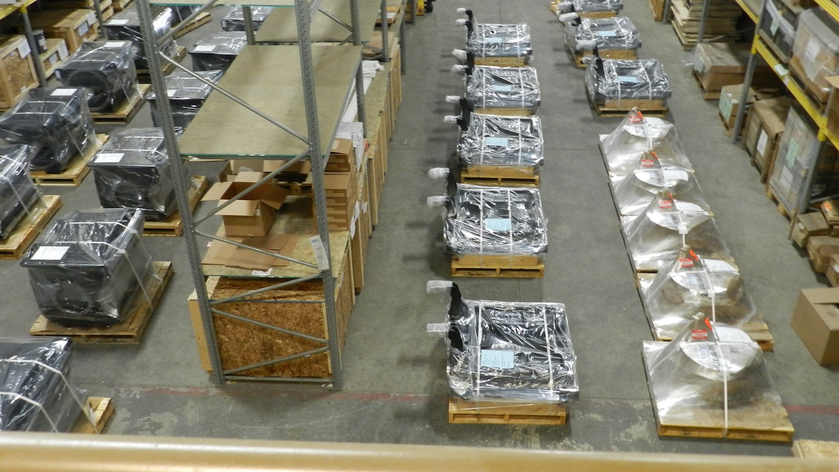 Mixed locomotive components on pallets — traction motors, generators, crated parts